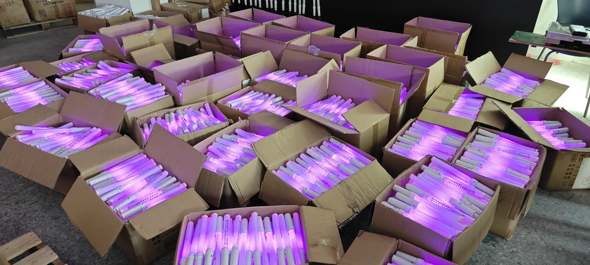 Finished LED glow sticks in cartons, illuminated in purple